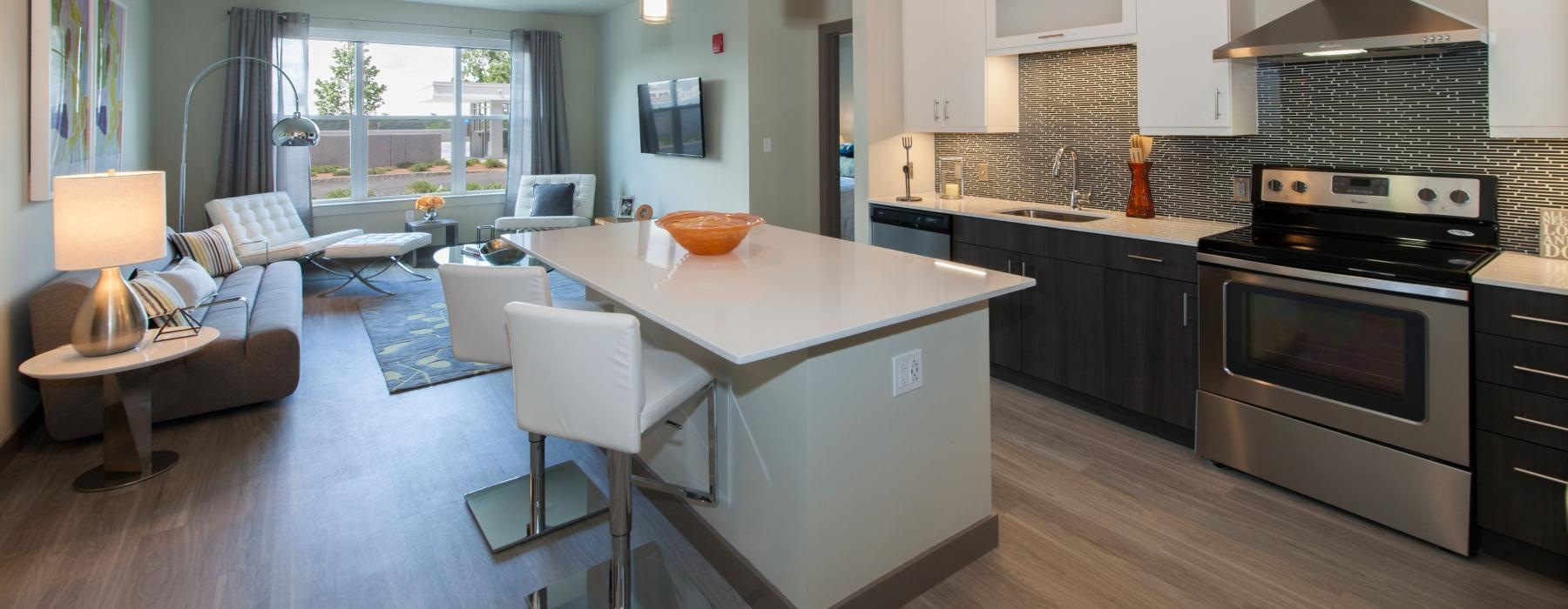 a kitchen with a bar and chairs