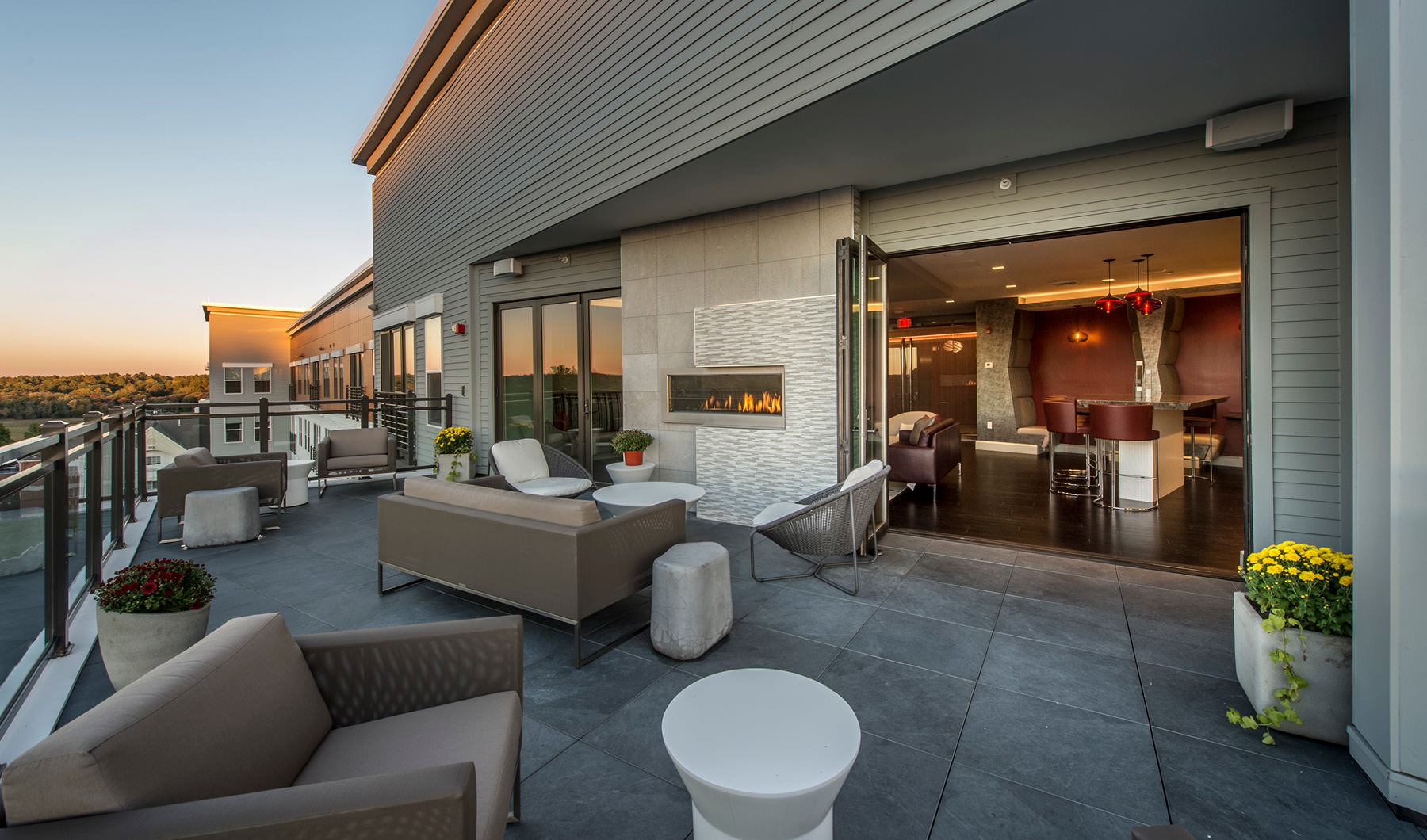 a patio with a couch and chairs